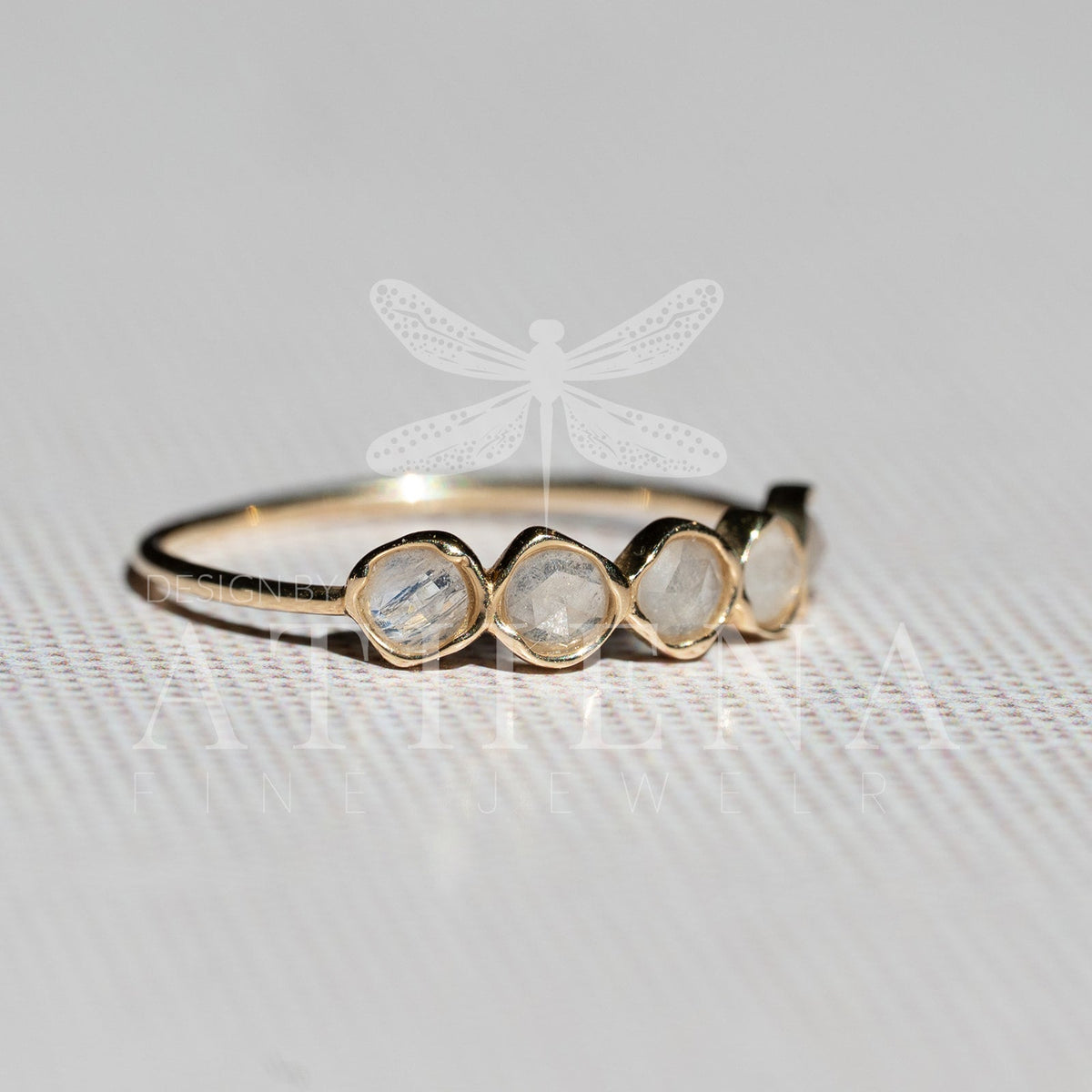 Close-up of a natural moonstone set in yellow gold