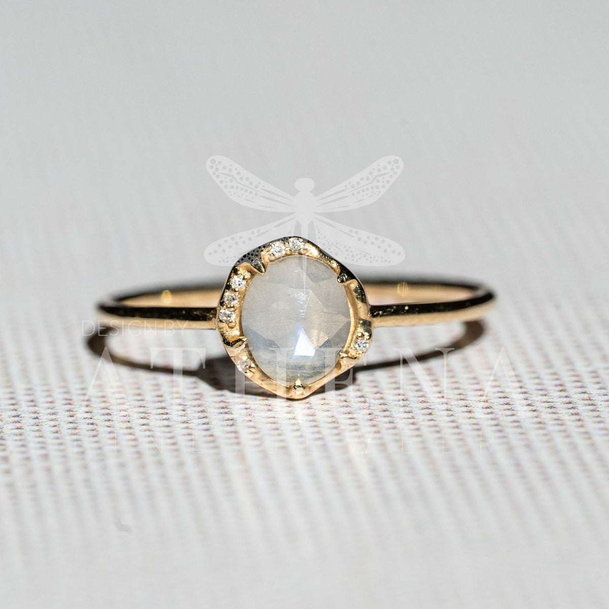 14K gold ring featuring a moonstone center stone and diamonds