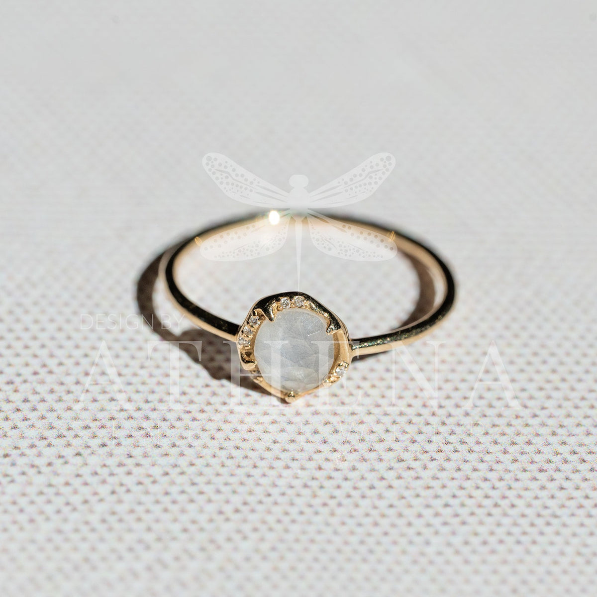 Moonstone solitaire and diamond accents on a yellow gold ring