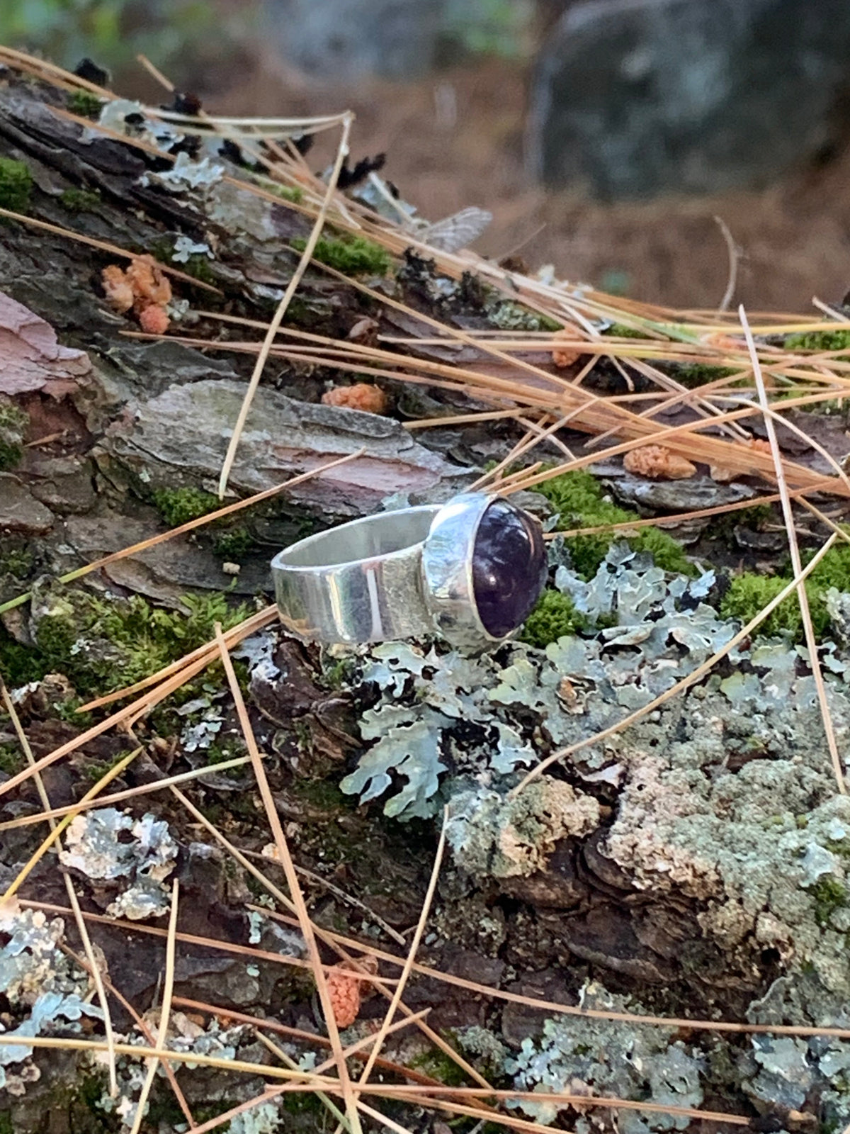 Close-up of a natural amethyst cabochon in silver