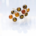 Sterling silver ring with a cluster of multitone Baltic amber