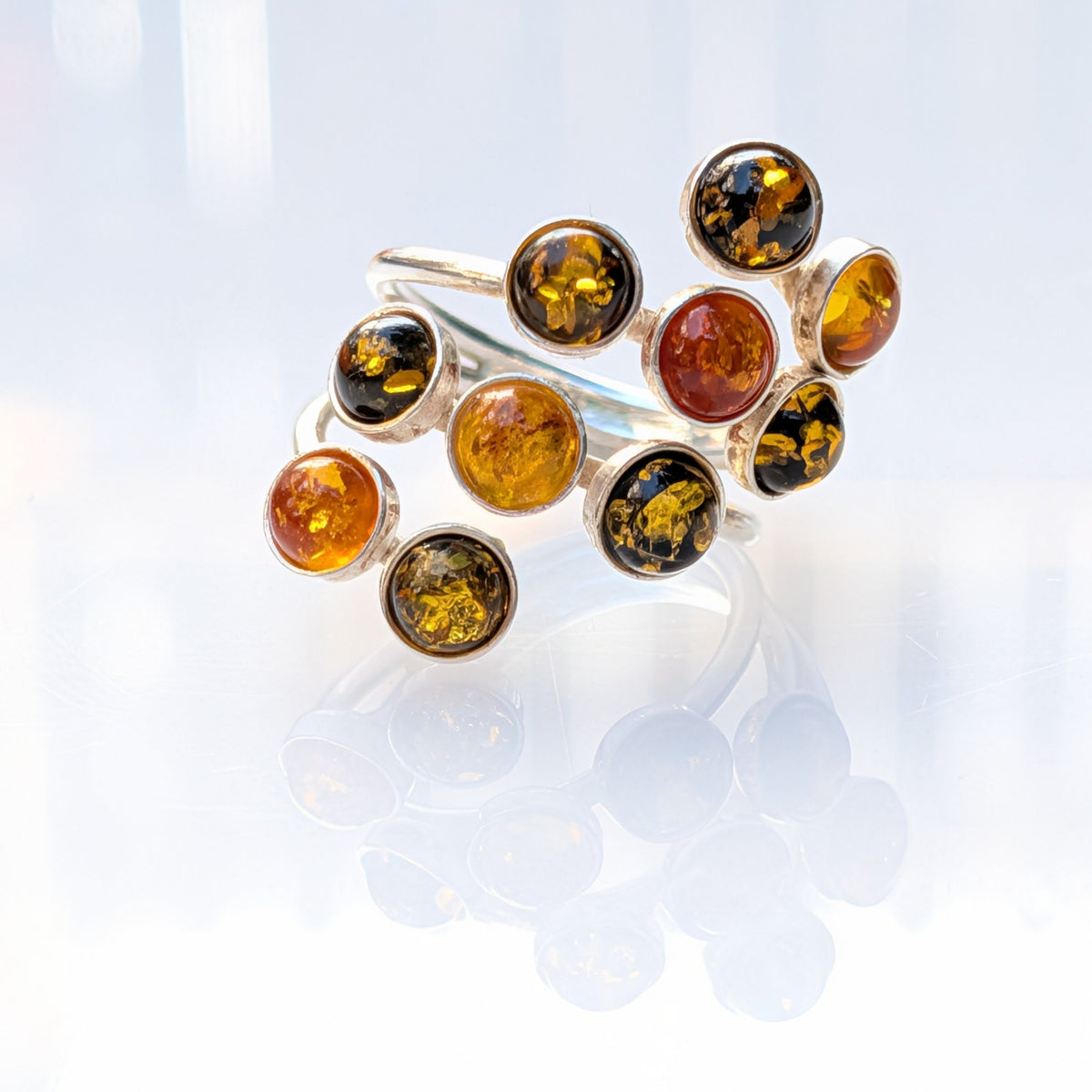 Sterling silver ring with a cluster of multitone Baltic amber