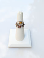 Sterling silver ring with golden Baltic amber in a flowing band