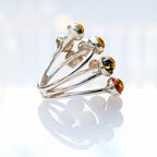 Close-up of round Baltic amber stones in a silver setting