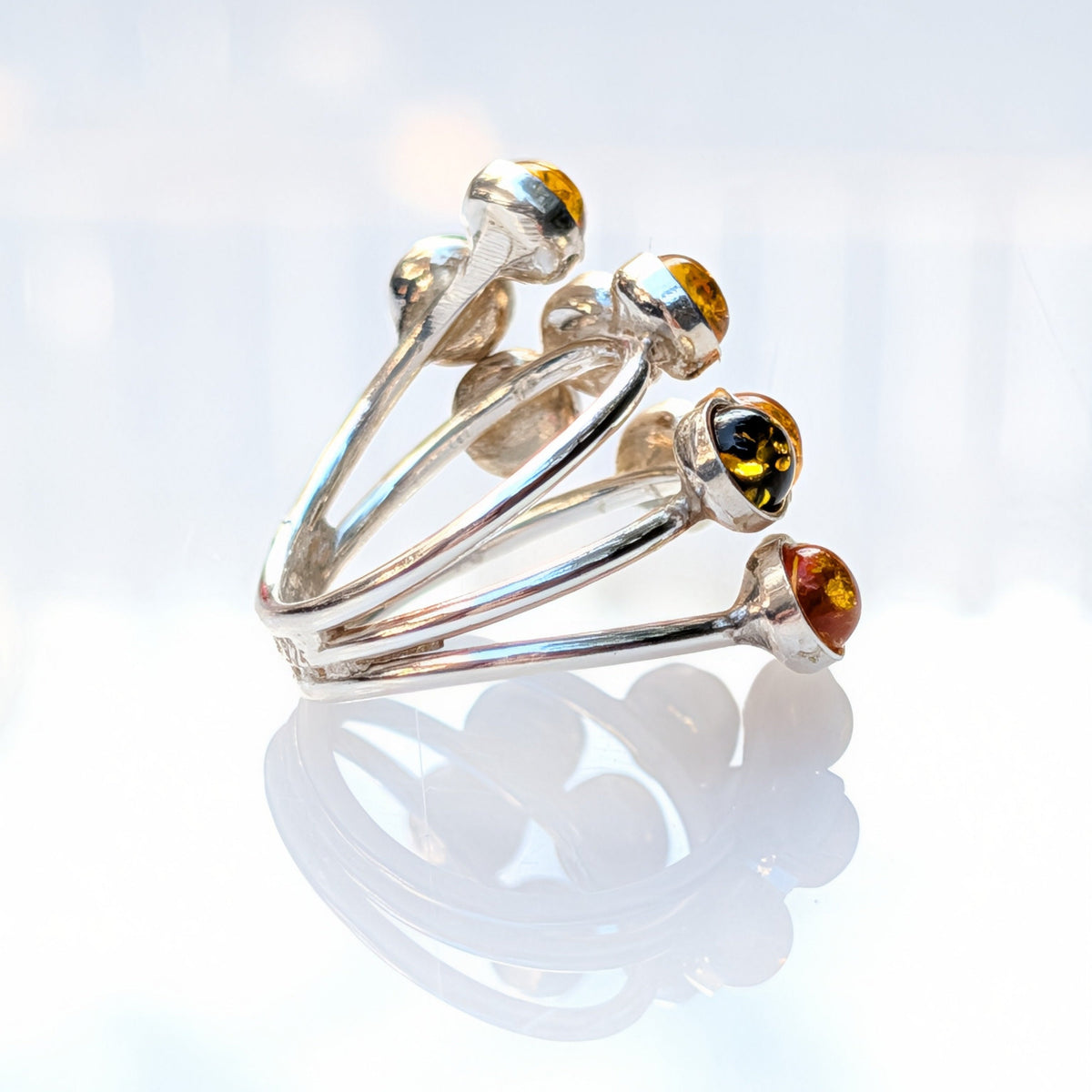 Close-up of round Baltic amber stones in a silver setting