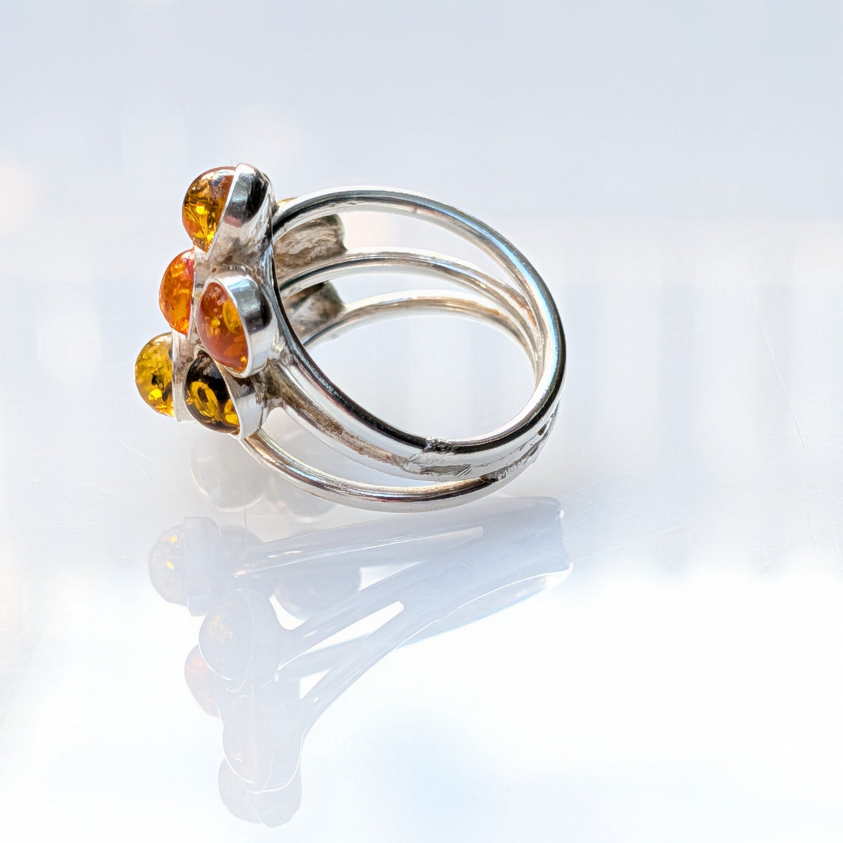 Honey and olive Baltic amber stones on a sterling silver ring