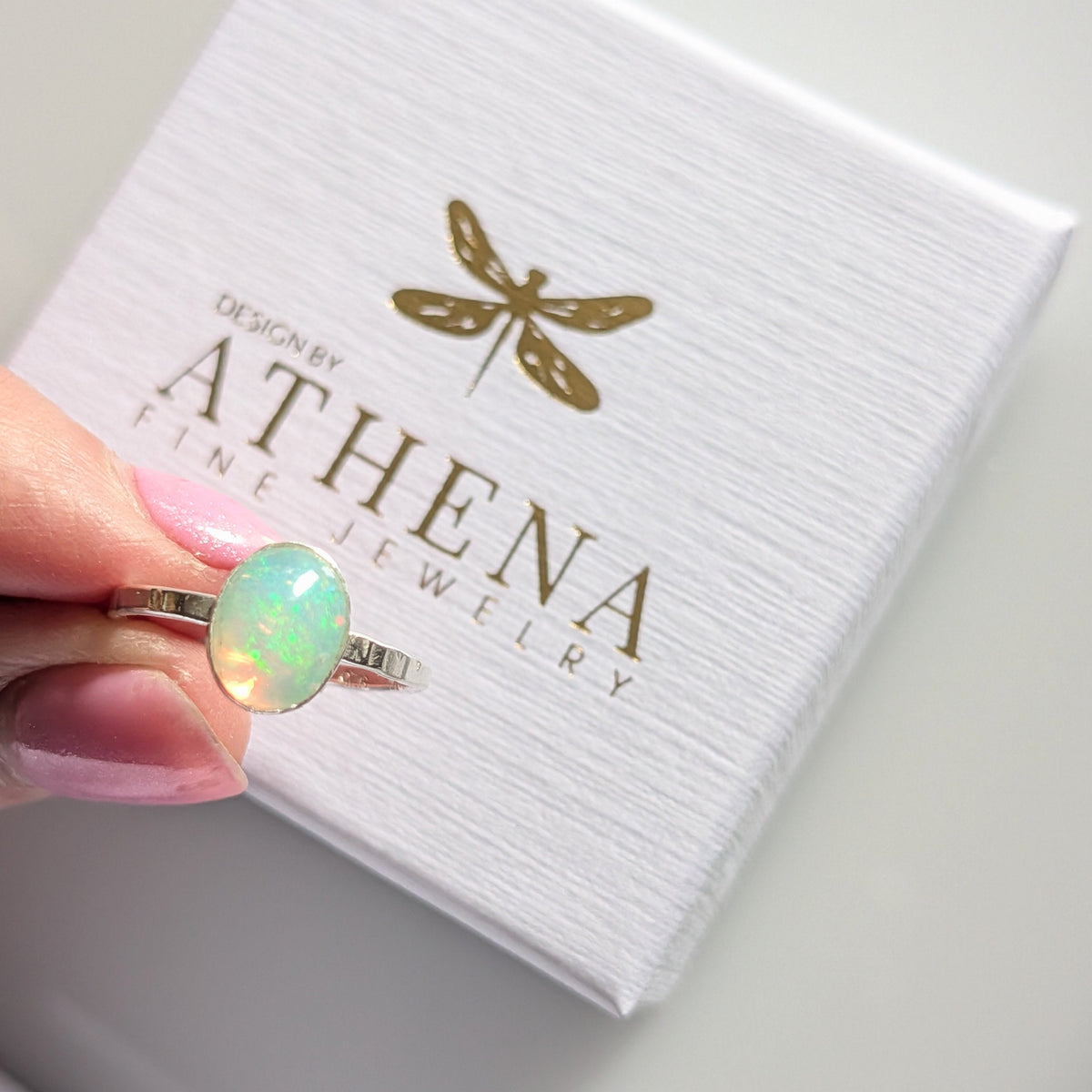 Oval fire opal ring in a handcrafted sterling silver bezel