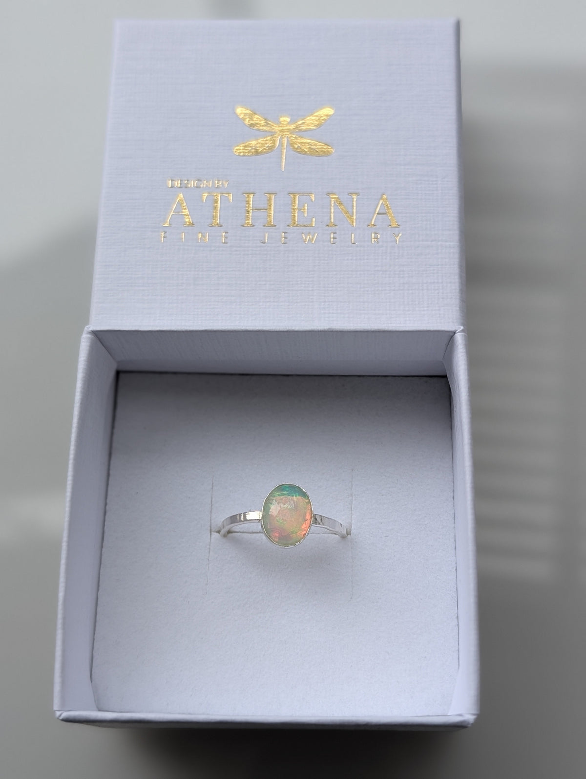 Fire opal ring photographed to show its soft internal glow